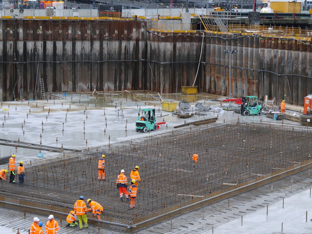 A group of construction workers standing around a construction site